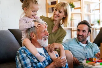 Cheerful multi-generation family having fun while spending time together at home