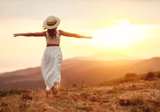 Happy woman standing with her back