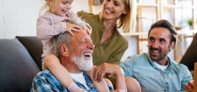 Cheerful multi-generation family having fun while spending time together at home