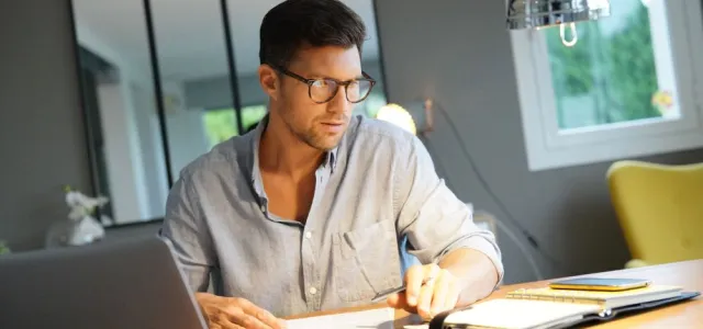 Middle-aged man working on laptop in office