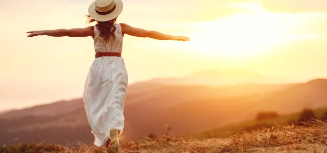 Happy woman standing with her back